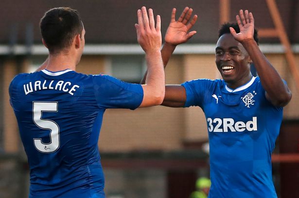 Rangers' Joe Dodoo celebrates scoring his side's third goal with team-mate Lee Wallace Rangers' Joe Dodoo celebrates scoring his side's third goal with team-mate Lee Wallace