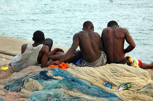 Fishermen relax before setting out to sea Fishermen relax before setting out to sea