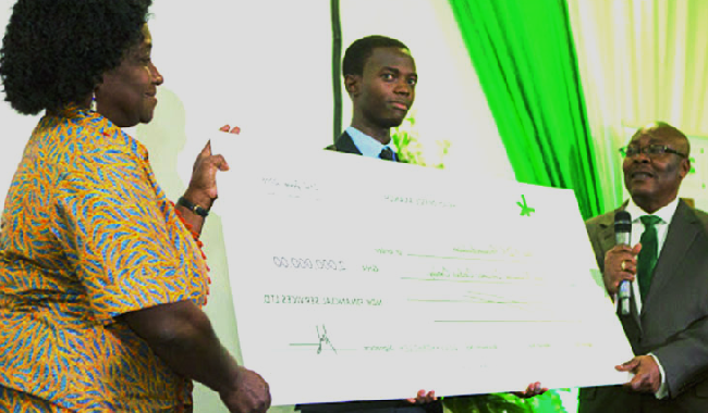 Prof. Ellen Aryeetey (right) receiving the dummy cheaque from Mr Oko-Nikoi Dzani, the founder of NDK Financial Services NDK launches CSR Foundation