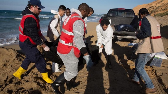 File photo from 20 March shows Libyan Red Crescent workers recovering bodies of drowned migrants from a beach east of the city of Tripoli, Libya. File photo from 20 March shows Libyan Red Crescent workers recovering bodies of drowned migrants from a beach east of the city of Tripoli, Libya.