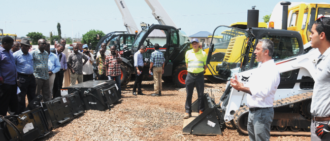 Mr Adem Urer, District Manager Africa, Dosan Infracore Construction Equipment, explaining to patrons how the new tractor works. Picture: EMMANUEL ASAMOAH ADDAI HMD unveils heavy-duty construction equipment