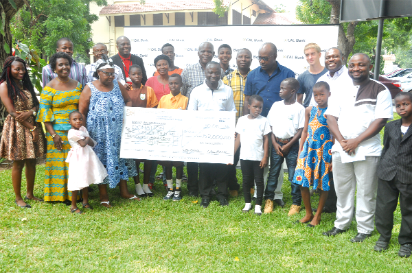 Mr Frank Adu Jnr. with the recipients after presenting the dummy cheque to them. Picture: SAMUEL TEI ADANO