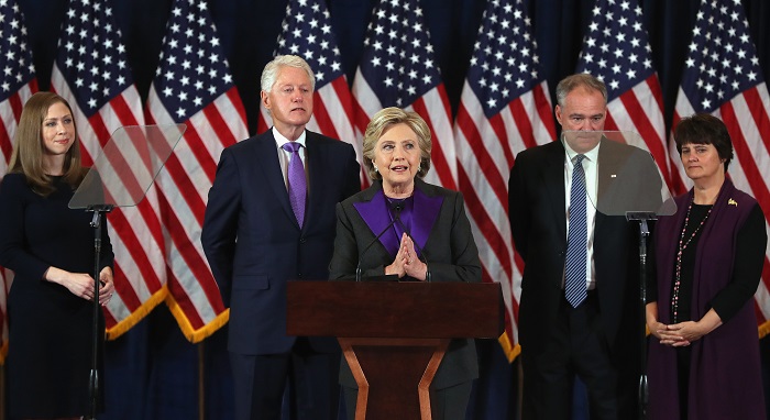 Mrs Clinton thanking her supporters yesterday shortly after conceding defeat to Donald Trump while Mr Clinton applauds his wife.