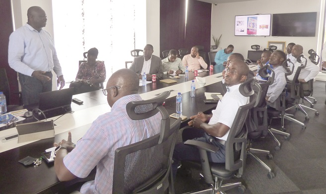 Nii Amah Dagadu (standing) supports Country Manager, Cecil Sunkwa-Mills (arrowed) to address members of the Network of Comm. Reporters. Nii Amah Dagadu (standing) supports Country Manager, Cecil Sunkwa-Mills (arrowed) to address members of the Network of Comm. Reporters.