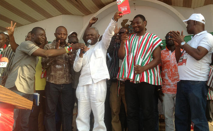 Dr Edward Mahama launching the manifesto in Bolga yesterday. With him include Mr Bernard Monah(2nd right), the National Chairman of the PNC. Picture:Vincent Amenuveve