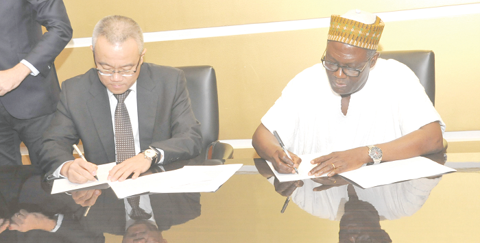 Mr Charles Abugre and Mr Xu Yingxin, Vice-President of China National Textile and Apparel Council appending their signatures to the documents. Picture: EBOW HANSON Mr Charles Abugre and Mr Xu Yingxin, Vice-President of China National Textile and Apparel Council appending their signatures to the documents. Picture: EBOW HANSON