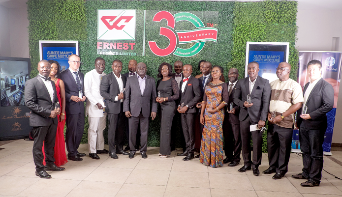 Mr Ernest Bediako Sampong (middle) with some of the representatives of the institutions that were honoured at the awards ceremony