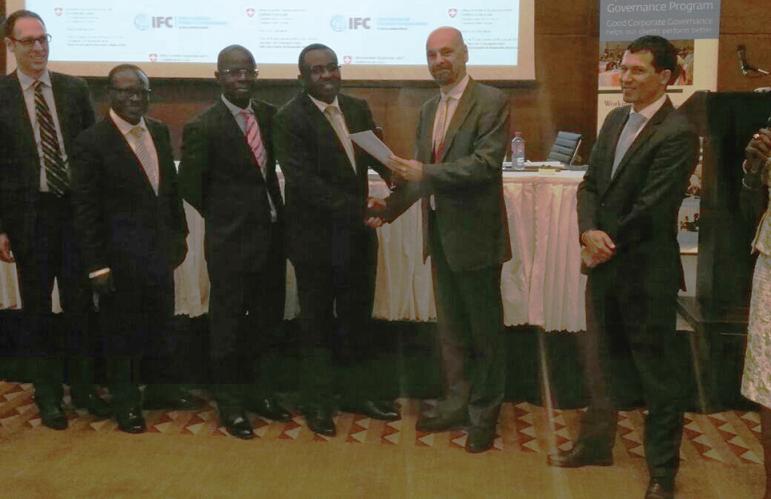 Mr Daniel Lauchenauer (right), Deputy Head of Cooperation, Counsellor-Swiss Embassy in Ghana, exchanging documents with Dr Johnson P. Asiama, at a ceremony held in Accra.