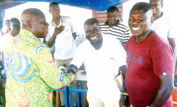 Mr Sersah-Johnson (left) interacting with some members of the Ekurofo Mpoano landing beach committee after the inauguration at Sekondi