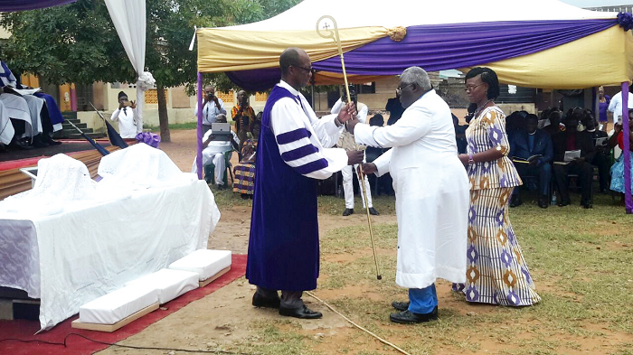 The Bishop Administrative Officer for the East Ghana Conference of the AMA Zion Church, Rev. Anthony Mensah (middle), presenting the staff to Rt Rev. Dr Dogbe The Bishop Administrative Officer for the East Ghana Conference of the AMA Zion Church, Rev. Anthony Mensah (middle), presenting the staff to Rt Rev. Dr Dogbe