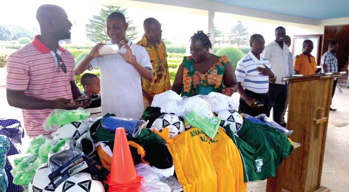 Some of the old students standing behind the items donated Some of the old students standing behind the items donated