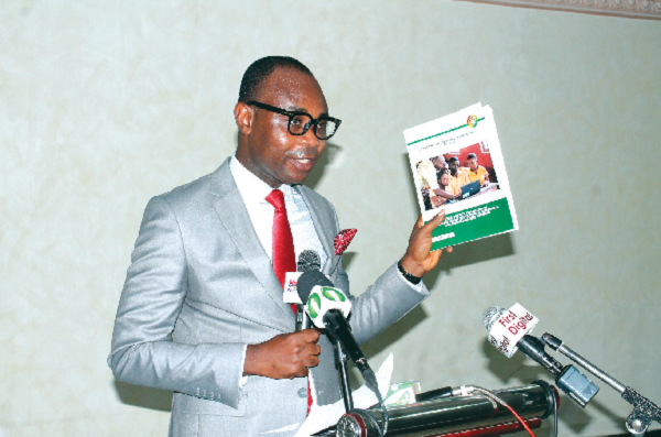 Mr Bright Appiah launching the report as a section of the participants look on