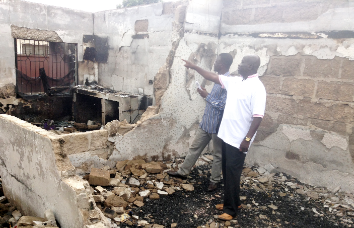 Nana Kofi Darko (hand stretched) showing our reporter debris of some of the items burnt inside one of the rooms Nana Kofi Darko (hand stretched) showing our reporter debris of some of the items burnt inside one of the rooms