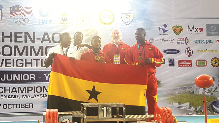 Forrester Osei with the weightlifting coach Dr Kyle Pierce and other members of the Ghanaian contingent at the championship Forrester Osei with the weightlifting coach Dr Kyle Pierce and other members of the Ghanaian contingent at the championship