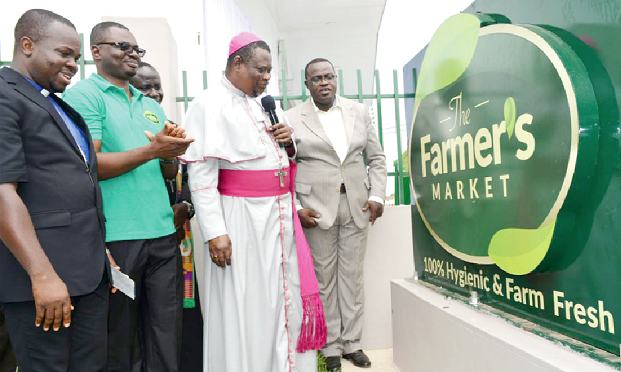 Rt Rev T.B Forson (in cassock) Bishop of the Tema Diocese of the Methodist Church and some dignitaries by the company's plague. INSET: Rt Rev T.B. Forson cutting the tape to officially open the retail outlet Rt Rev T.B Forson (in cassock) Bishop of the Tema Diocese of the Methodist Church and some dignitaries by the company's plague. INSET: Rt Rev T.B. Forson cutting the tape to officially open the retail outlet