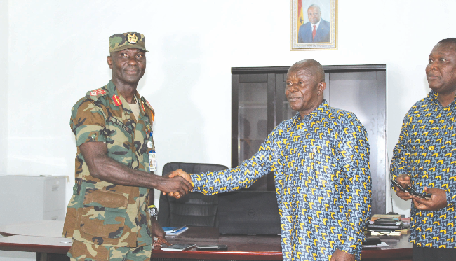 Brig-General Stanley Brian Alloh thanking Mr Ernest Agbesi, MD of GCB Bank (2nd right)