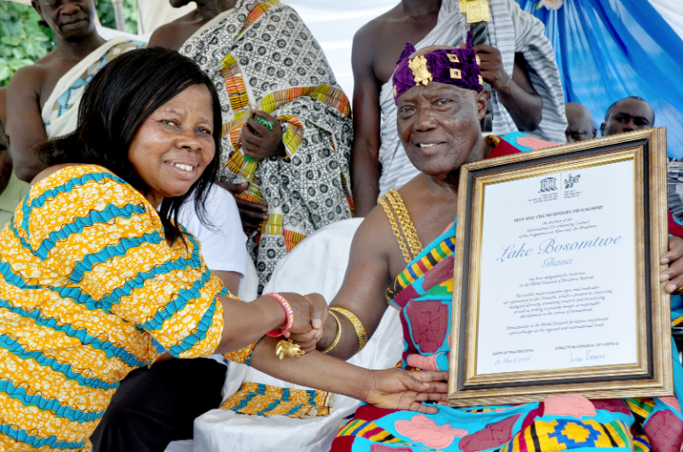 Otumfuo’s Adontenhene, Nana Adu Gyamfi (right), presenting the certificate to Mrs Veronica Antwi Adjei, the DCE of the Bosomtwe District Lake Bosomtwe designated UNESCO world site