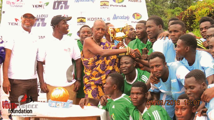 Nana Kwaa Tentenele (in cloth), presenting the Unity Cup to the captain of the Upper Axim team, supporterd by the MCE of Nzema East (second left), Mr James Atta Kakra Baidoe Nana Kwaa Tentenele (in cloth), presenting the Unity Cup to the captain of the Upper Axim team, supporterd by the MCE of Nzema East (second left), Mr James Atta Kakra Baidoe