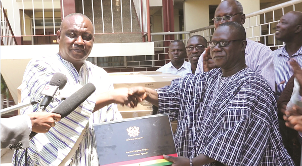 Mr Alex Kyeremeh (left), presenting the laptops to Dr Peter Atefuah