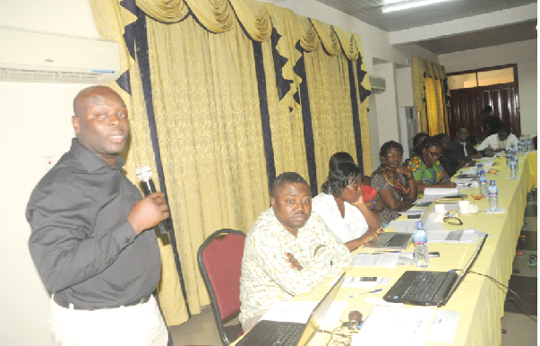 • Mr Frank Ohene Annor (left), a Research Fellow at Tu-Delft in the Netherlands, addressing the workshop in Accra NADMO introduces early warning system on flooding