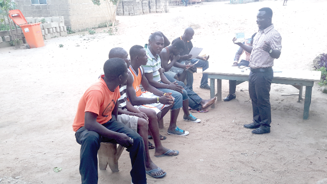 Mr Innocent Donkor explaining a point to young men at Top Town Apeedwa Mr Innocent Donkor explaining a point to young men at Top Town Apeedwa