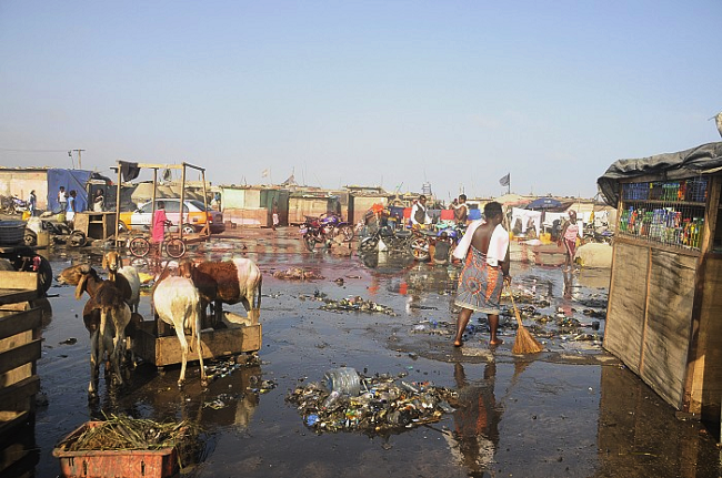 Some women clearing the debris at the Light House fish market near Usher Fort in James town-Accra How prepared are we for tidal waves, national emergencies?