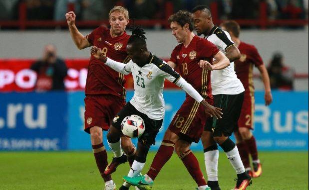 Harrison Afful sandwiched by his Russian markers during the match Harrison Afful sandwiched by his Russian markers during the match