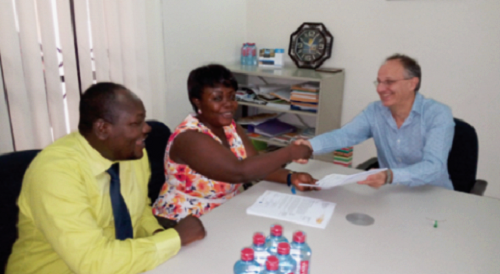Mrs Regina Kumi exchanging pleasantries with Nicolas Jørgensen Gebara, the BUSAC Fund Manager. Looking on is Mr Borbor Frank Mawutor BUSAC Fund extends support to money lenders