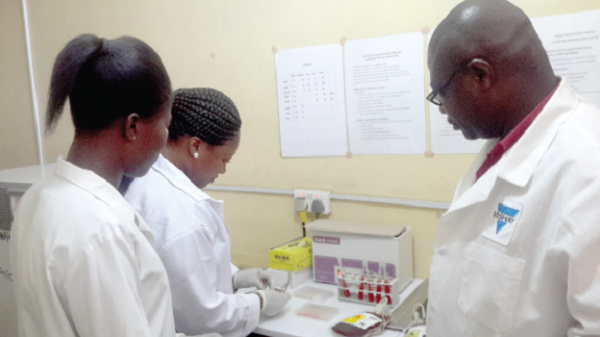 Mrs Jennifer Annan (middle), a Senior Biomedical Laboratory Scientist in charge of the blood transfusion facility at the polyclinic, crossmatching blood collected with Dr Patrick Amo-Mensah (right) and Ms Sarah Frempong looking on Kaneshie Polyclinic begins blood transfusion services