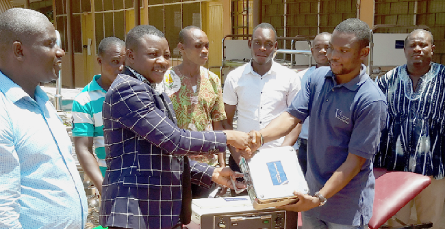 Mr Issah Mohammed Bataglia (right) presenting the items to Mr Alex Bapula, the Sissala-East District Director of Health Services, during the brief ceremony. INSET: Some of the items that were donated NGO donates equipment to health institutions