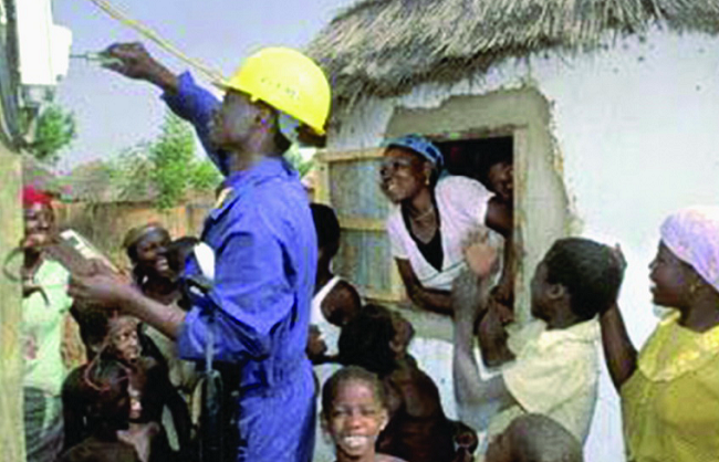 An ECG worker turning the power on Seven communities in Central Tongu get power