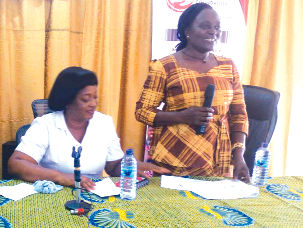 Mrs Millicent Akoto (standing) speaking at the launch of the project Skills training project for widows launched in Accra