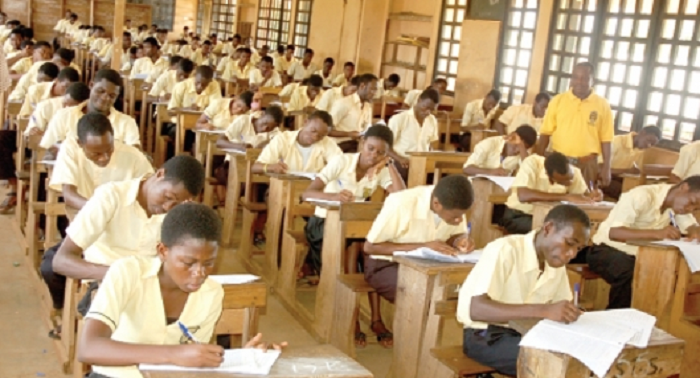 An invigilator supervising BECE students