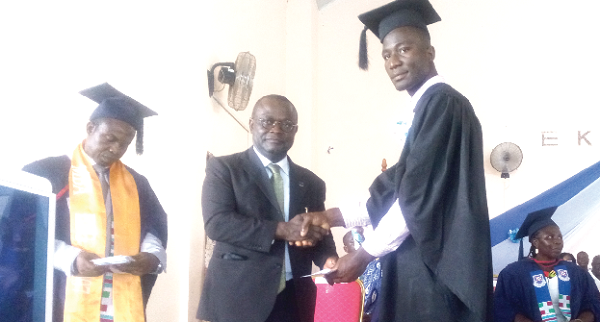 Prof. Ebenezer Oduro Owusu (left) presenting a prize to one of the First Class students Prof. Ebenezer Oduro Owusu (left) presenting a prize to one of the First Class students