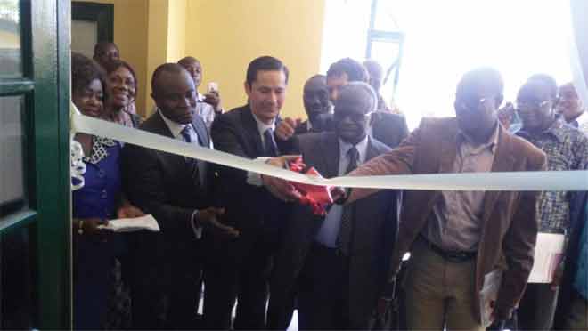 Dr Victor Agyemang (4th left ), the Director-General of the CSIR, being assisted by Mr Daniel Lauchenauer (3rd left) to cut the tape to inaugurate the refurbished laboratory Dr Victor Agyemang (4th left ), the Director-General of the CSIR, being assisted by Mr Daniel Lauchenauer (3rd left) to cut the tape to inaugurate the refurbished laboratory