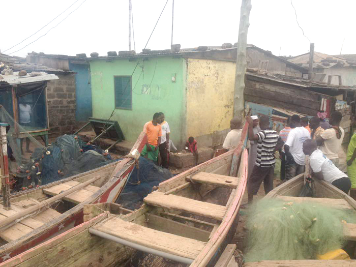 Some fisherfolk in the Aboadze community assessing the extent of damage caused by the waves Some fisherfolk in the Aboadze community assessing the extent of damage caused by the waves