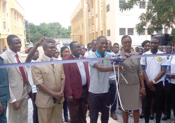 Mrs Ohenewa Sakyi Bekoe and Mr Emmanuel Kofi Poku in the company of other dignitaries cutting a tape to officially open the service centre