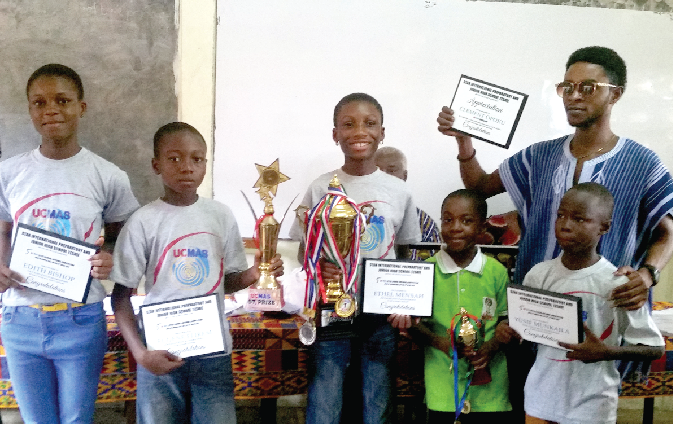Pupils of the Star International School together with their UCMAS coach displaying their trophies and plaques. Pupils of the Star International School together with their UCMAS coach displaying their trophies and plaques.