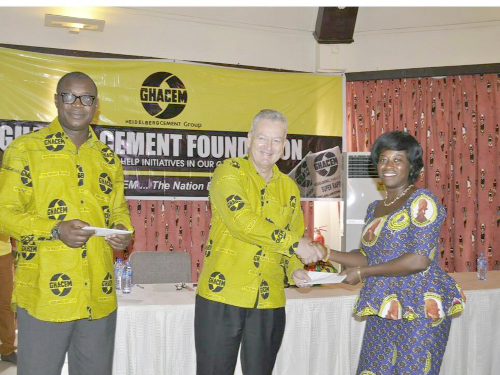 Mr Morten Gade (middle) handing a cement allocation letter to one of the beneficiaries. Looking on is Dr George Dawson-Ahmoah Mr Morten Gade (middle) handing a cement allocation letter to one of the beneficiaries. Looking on is Dr George Dawson-Ahmoah