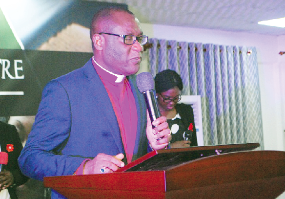 Reverend Dr Ernest Adu-Gyamfi preaching the sermon. A section of the congregation 