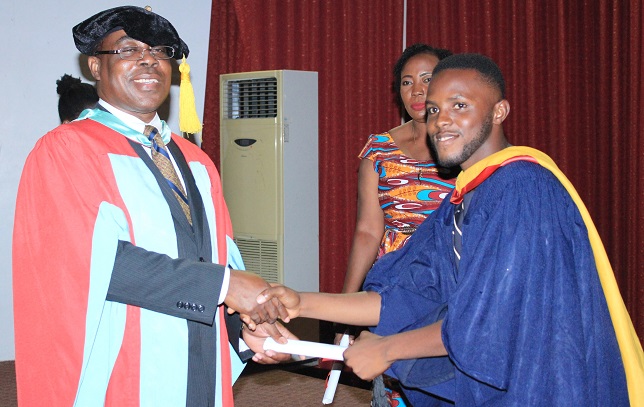 Mr David Essuman, Dean of Social Science, University of Cape Coast, honouring Onyemefolu Richmond as one out of gradands who  had first class in Tourism and Hospitality Management
