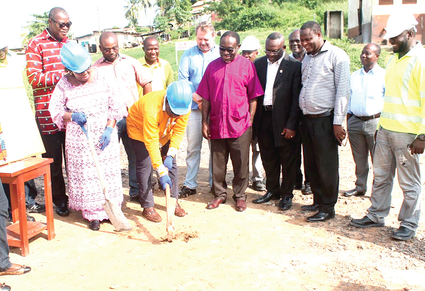 Mr K.K. Sam (with pickaxe joined by Mrs Alberta Cudjoe to break grounds to officially start the project. Looking on are Ghacem officials and dignitaries present Mr K.K. Sam (with pickaxe joined by Mrs Alberta Cudjoe to break grounds to officially start the project. Looking on are Ghacem officials and dignitaries present
