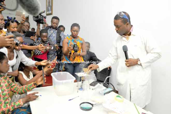 Mr Cheetam Mingle demonstrating the testing of genuine and fake rice at the press conference. Picture: EMMANUEL QUAYE Mr Cheetam Mingle demonstrating the testing of genuine and fake rice at the press conference. Picture: EMMANUEL QUAYE
