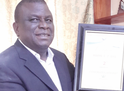 Mr Cephas Edusei, headmaster, displaying the shield after his school had been adjudged the second best second cycle institution in the Volta Region