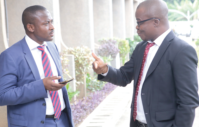 Mr Kwesi Eghan (right), Assistant Commissioner, Adabraka MTO, interacting with Mr Farouk Hamza, the Head of Audit, Adabraka, MTO, after the seminar