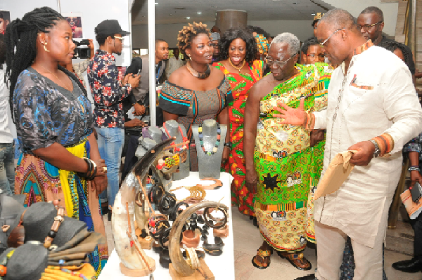 Mr Akonu Dake (right), co-convener of the Ghana Culture forum conducting Mr Osafo-Maafo (2nd right) around the exhibits mounted as part of the forum. Also among them is Mrs Catherine Afeku (3rd right).