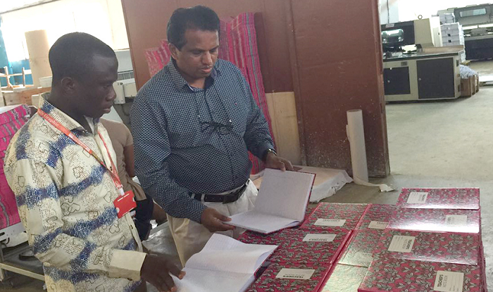 Mr Thampi (right) taking our reporter through the differences between locally manufactured exercise books and imported ones Mr Thampi (right) taking our reporter through the differences between locally manufactured exercise books and imported ones