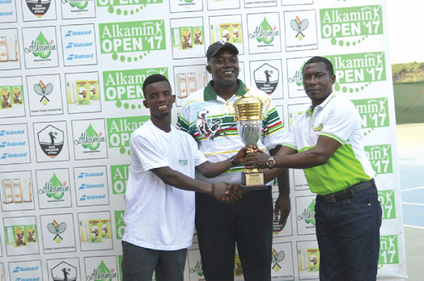 Dr Antwi Tetteh of Rockcare Group presenting the trophy to Ben Fumi, winner of the competition, while Mr Isaac Duah looks on Dr Antwi Tetteh of Rockcare Group presenting the trophy to Ben Fumi, winner of the competition, while Mr Isaac Duah looks on