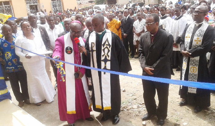 Rt Rev. Andam (holding scissors) cutting the tape to inuagurate the new manse (inset) at Oforikrom in Kumasi while Rev. Osei Karikari (right) and others look on Rt Rev. Andam (holding scissors) cutting the tape to inuagurate the new manse (inset) at Oforikrom in Kumasi while Rev. Osei Karikari (right) and others look on