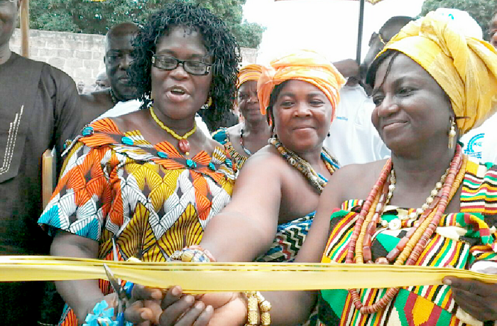 Madam Angelina Attakey (left), an education officer at the Kpando Municipality, being assisted by Madam Comfort Addai (right) to cut the tape Madam Angelina Attakey (left), an education officer at the Kpando Municipality, being assisted by Madam Comfort Addai (right) to cut the tape